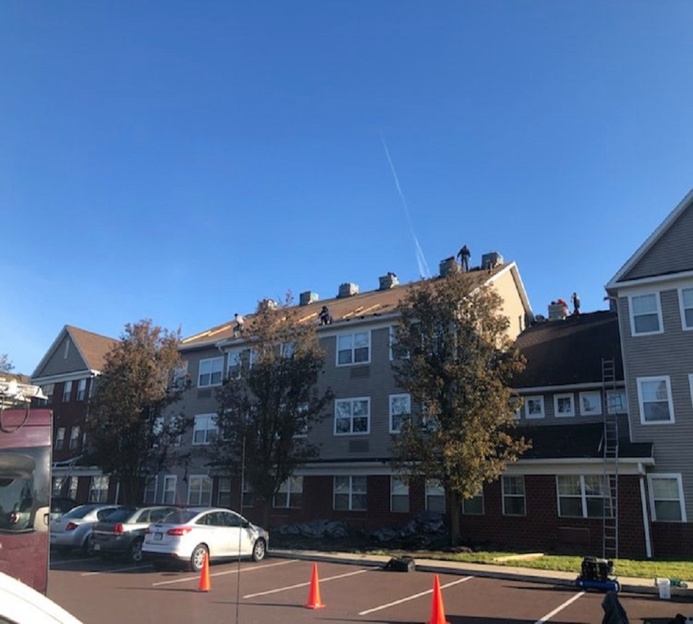 Apartment building shingle roof replacement by XL Home Improvements.