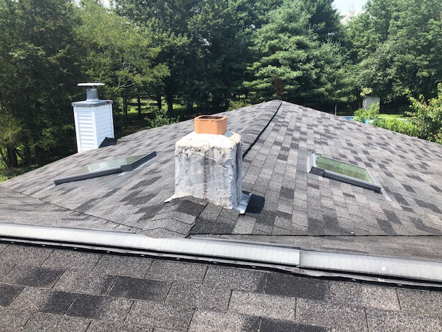 XL Home Improvements did a complete gambrel roof replacement in Harleysville PA, including five new skylights and custom copper chimney flashing.