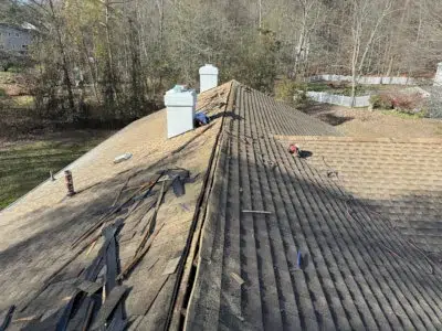 Ridge vent installation in progress on a residential roof in King of Prussia, PA, showing the roof ridge stripped open for new vent installation.