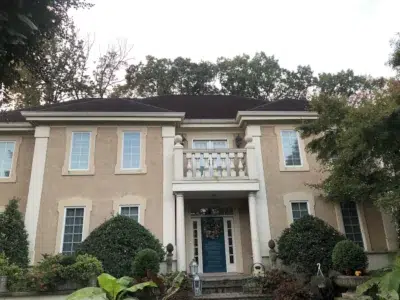 Large stately home with old, weathered roof before shingle roof replacement.