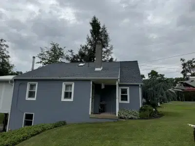 Front view of a residential home in Skippack, PA, showcasing a newly completed shingle roof with Biscayne Blue GAF Timberline HDZ shingles.