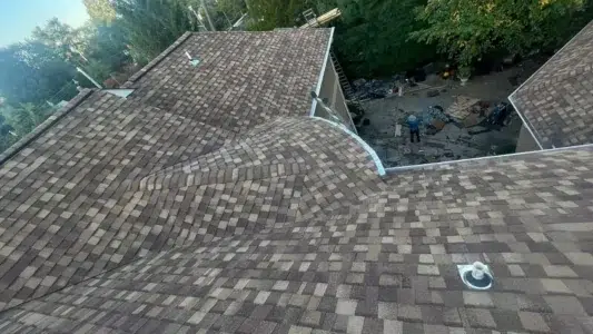 On-roof view of completed residential roof with CertainTeed Landmark Pro Resawn Shake shingles by XL Home Improvements.