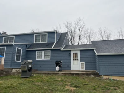 Backside of a Berwyn, PA home with new siding and a complete gutter system installed by XL Home Improvements to protect the house from the elements.