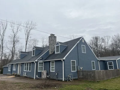 Full property view of a Berwyn, PA home with new CertainTeed Cedar Impressions Pacific Blue siding and new gutters installed by XL Home Improvements, including second story resided due to exceptional quality.