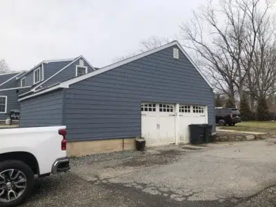 Garage portion of a Berwyn, PA home after new siding installation by XL Home Improvements, highlighting the transformation from dull, worn old siding to fresh, vibrant new siding.
