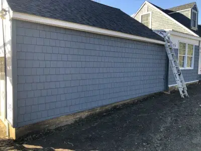 Front of a home in Berwyn, PA with Certainteed Cedar Impressions Pacific Blue siding installation on the garage and front facade by XL Home Improvements.