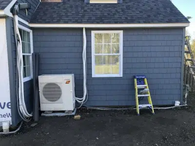 Portion of a home in Berwyn, PA with new siding installed by XL Home Improvements, showing a flush fit around new windows installed by Wolf Home Pros.