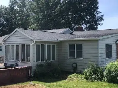 Corner-view image of a home showcasing the fully completed shingle roof replacement.