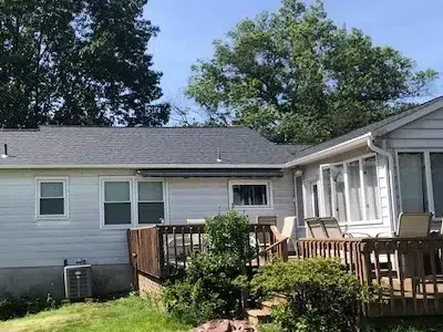 Backside view of a home showcasing the fully installed new shingle roof completed by XL Home Improvements in Perkasie, PA.