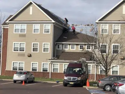 Commercial Shingle Roof Installation – Park View at Oak Crest, Harleysville, PA | XL Home Improvements Roofers installing new shingles on a commercial roof at Park View at Oak Crest in Harleysville, PA by XL Home Improvements.