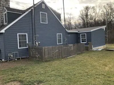Side of a home in Berwyn, PA fully resided by XL Home Improvements, showcasing the completed siding installation.
