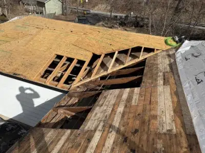 Rotted decking removed from outhouse roof during Schwenksville roof replacement project by XL Home Improvements.