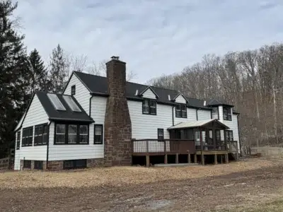 Completed roof replacement on Schwenksville home with custom copper valleys, Tamko Heritage shingles, and skylights.