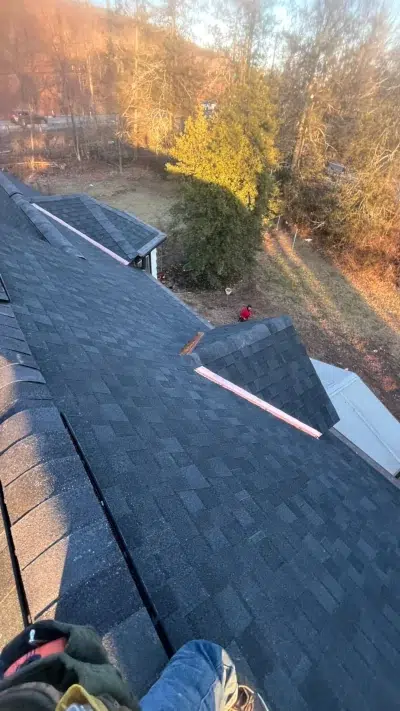 Roofer’s perspective showing custom copper valleys and Tamko Heritage "Rustic Black" shingles on the roof of a Schwenksville home.