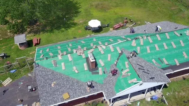 Roof installation in progress in Schwenksville PA showing underlayment and roofing crew working on residential home
