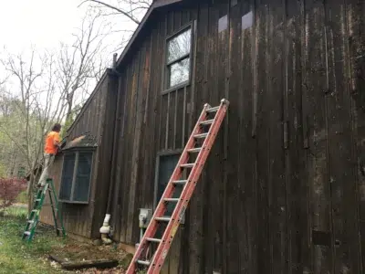 Damaged board and batten siding before replacement in Trumbauersville PA