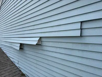 Damaged and loose siding panels before repair in East Norriton Township PA by XL Home Improvements