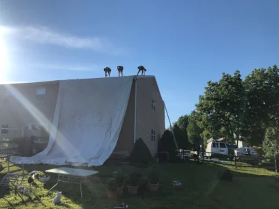 Roof replacement preparation with tarp protection on twin home in Lansdale PA