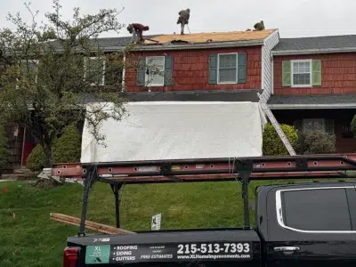 roof tear-off in Schwenksville PA townhome showing decking exposed during replacement