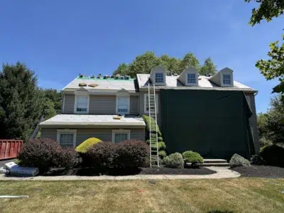 Roof replacement in progress on home in Collegeville PA with exterior protection and underlayment installed