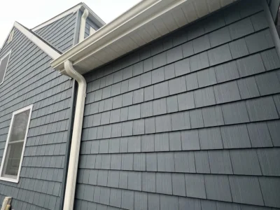 Close-up of shake style siding installation, trim detail and new gutters on a home in Berwyn, PA by XL Home Improvements